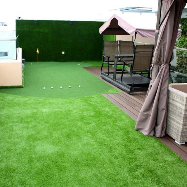 Wall Clad with Synthetic Turf to Soften to Impact of Golf Balls
